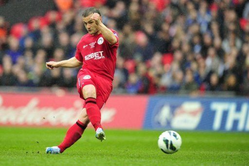 Wigan Athletic&#039;s Shaun Maloney shoots to score at Wembley Stadium in north London, April 13, 2013