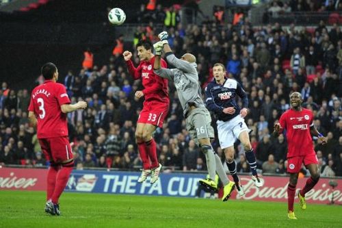 Wigan Athletic's goalkeeper Ali Al Habsi (3rd L) punches the ball clear at Wembley Stadium, April 13, 2013