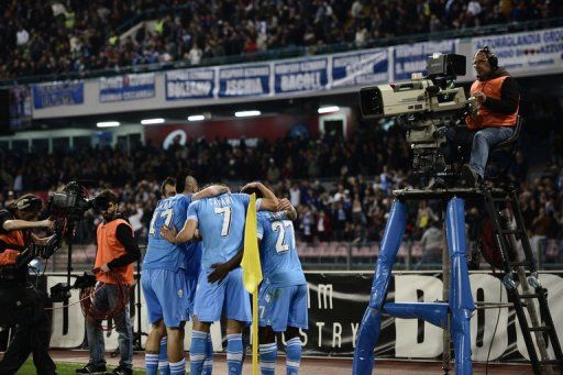 Napoli&#039;s players celebrate after scoring against Genoa, in Naples, on April 7, 2013