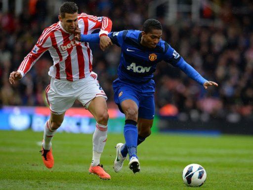 United&#039;s Antonio Valencia (right) vies with Geoff Cameron in Stoke-on-Trent on April 14, 2013