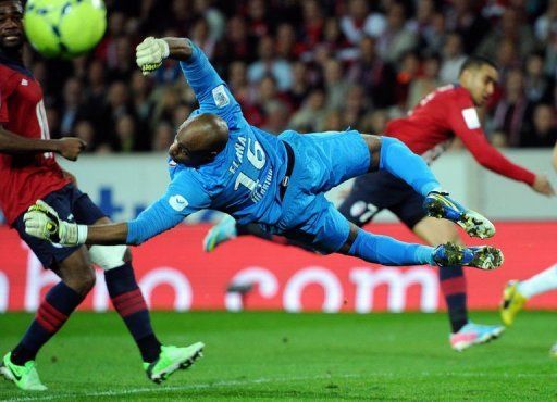 Lille&#039;s goalkeeper Steeve Elana dives to catch the ball on April 14, 2013 at the 