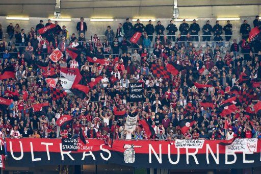 Nuremberg fans watch the match against Bayern Munich in Munich on April 13, 2013