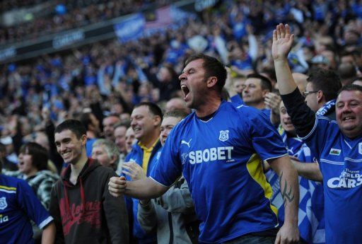 Cardiff City fans celebrate a goal at Wembley Stadium in London, on February 26, 2012