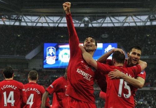 Wigan Athletic midfielder Paul Scharner (C) celebrates during their FA Cup match against Millwall on April 13, 2013