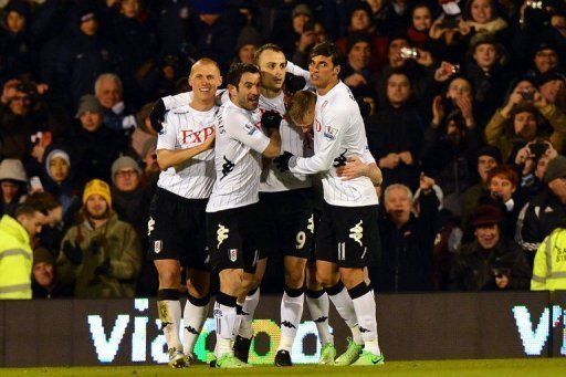 Fulham&#039;s Dimitar Berbatov (C) celebrates after scoring during their Premier League match against QPR on April 1, 2013