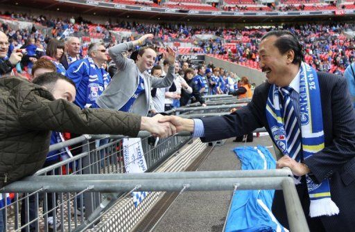 Cardiff owner Vincent Tan (R) greets fans before the start of the League Cup Final against Liverpool, February 26, 2012