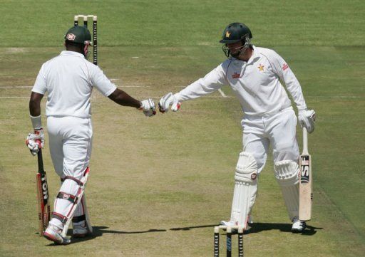 Zimbabwe batsman Hamilton Masakadza (L) and Brendan Taylor touch gloves in Harare on April 17, 2013