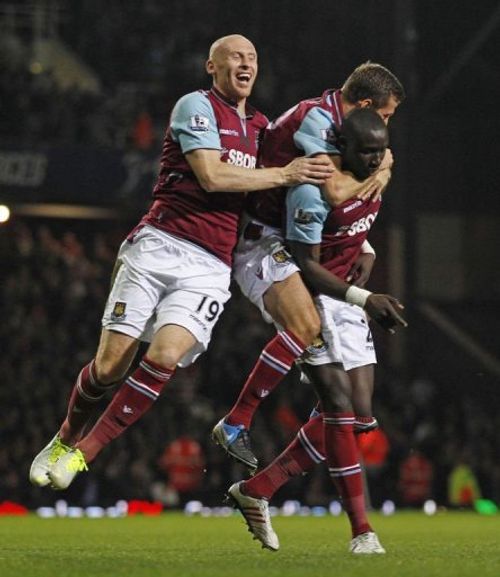 West Ham's Mohamed Diame (R) celebrates scoring with James Collins (L) and Gary O'Neil (C) in London on April 17, 2013