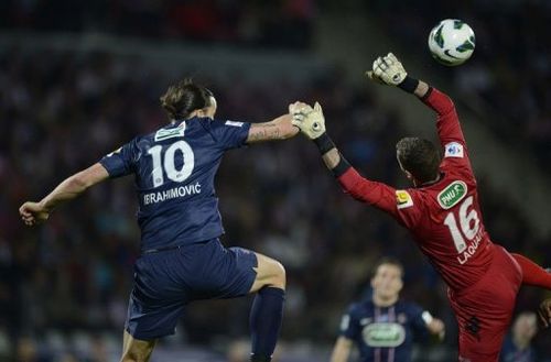 Paris' Zlatan Ibrahimovic (L) fights for the ball with Evian's goalkeeper Johann Durand (R) on April 17, 2013 in Annecy