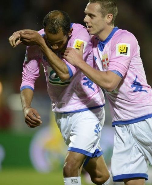 Evian's Saber Kalhifa (L) is congratulated by his teammate Kevin Berigaud (R) after scoring on April 17, 2013 in Annecy