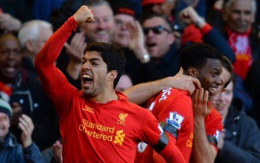 Liverpool&#039;s Luis Suarez (L) celebrates scoring in Liverpool, northwest England, on April 21, 2013