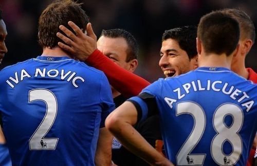 Liverpool striker Luis Suarez tries to make peace with Chelsea defender Branislav Ivanovic on April 21, 2013