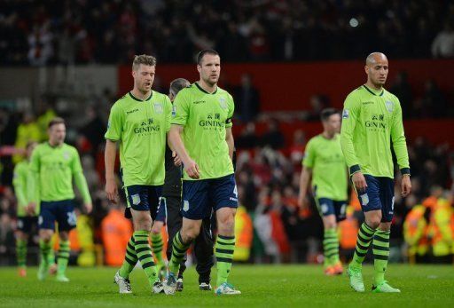 Aston Villa players leave the pitch after losing 3-0 to Manchester United at Old Trafford in England on April 22, 2013