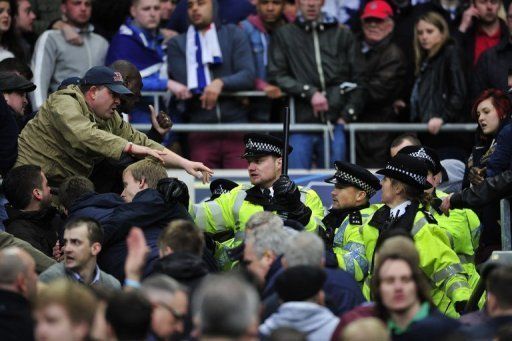 Millwall fans clash with police during the FA Cup semi-final against Wigan at Wembley Stadium on April 13, 2013