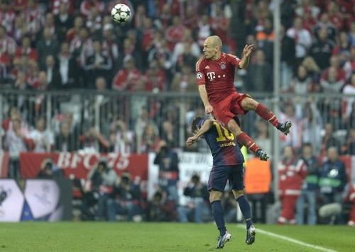 Bayern Munich winger Arjen Robben rises above Barcelona's Jordi Alba on April 23, 2013