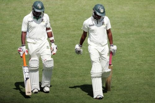 Bangladesh's SK Robiul Islam (L) and Rubel Hossain walk off the pitch during the first Zimbabwe test on April 19, 2013