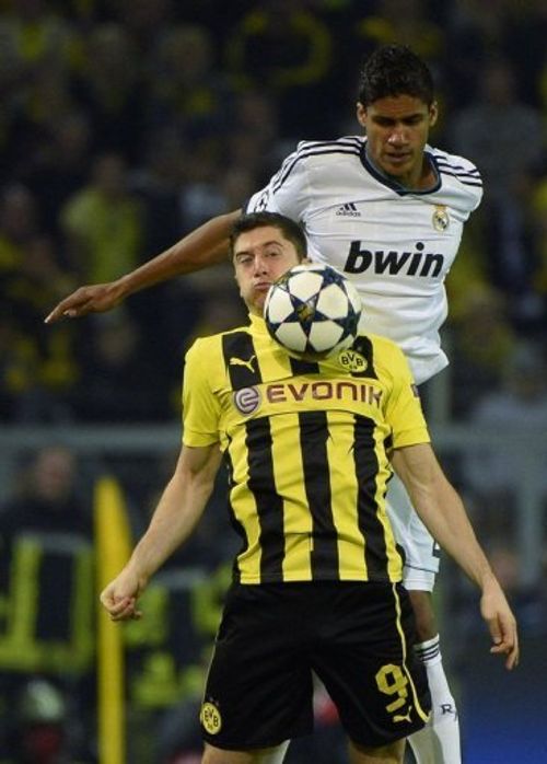 Real Madrid's Raphael Varane and Dortmund's Robert Lewandowski vie for the ball on April 24, 2013