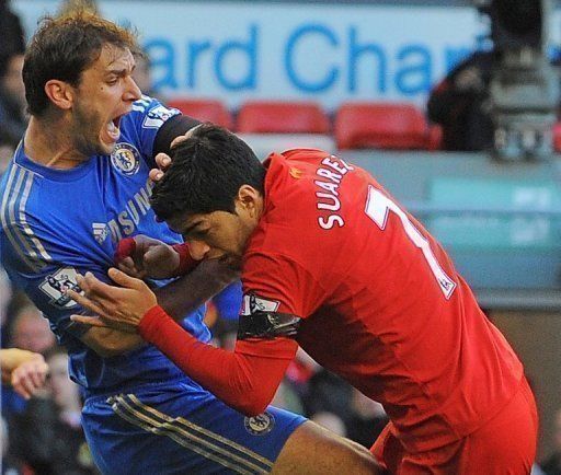 Luis Suarez (right) clashes with Branislav Ivanovic after biting him at Anfield on April 21, 2013