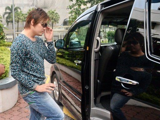Businessman Eric Ding Si Yang, 31, walks to a waiting car outside the Subordinate courts in Singapore on April 9, 2013