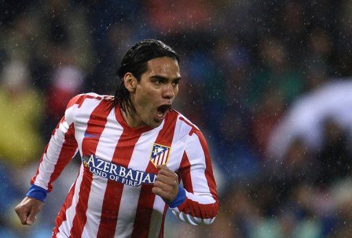 Atletico Madrid forward Radamel Falcao celebrates scoring against Valencia on March 31, 2013