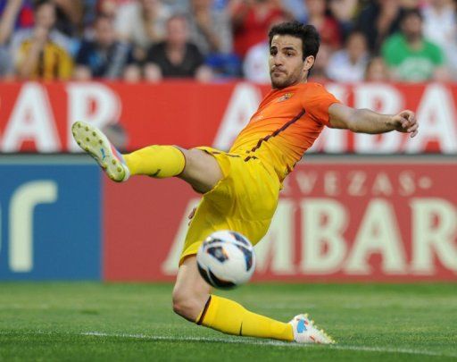 Barcelona midfielder Cesc Fabregas stretches for the ball on April 14, 2013