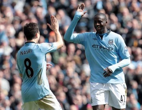 Manchester City's Yaya Toure (right) celebrates his goal against West Ham with Samir Nasri in Manchester, April 27, 2013