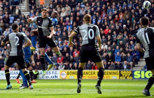 Wigan Athletic&#039;s defender Emmerson Boyce (3rdR) scores from a header in Wigan, on April 27, 2013