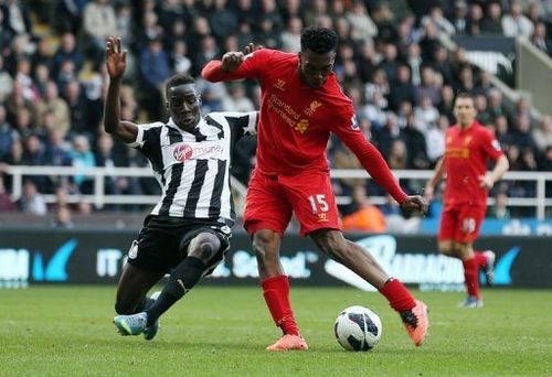 Liverpool's striker Daniel Sturridge (R) shoots to score a goal at St James' Park in Newcastle, April 27, 2013