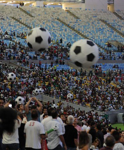 Spectators for the test event at the Maracana on April 27, 2013 watch an exhibition match