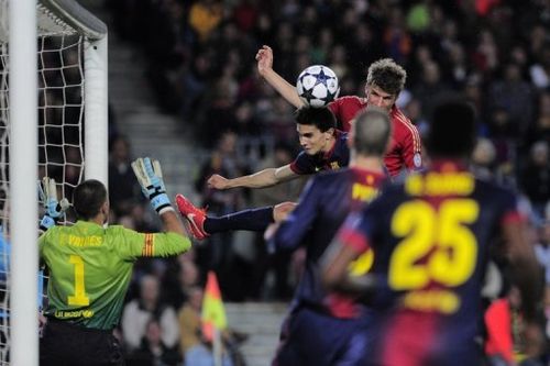 Bayern's Thomas Mueller (top R) heads the ball during their Champions League match against Barcelona on May 1, 2013