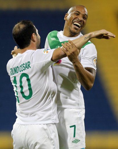 Al Ahli&#039;s Victor (R) celebrates with teammate Bruno Cesar after scoring on April 23, 2013