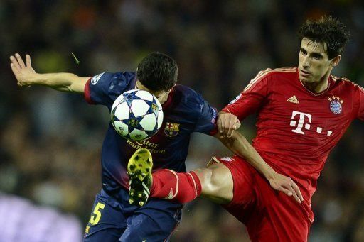 Barcelona&#039;s Marc Bartra (left) is challenged by Bayern Munich&#039;s Javier Martinez at the Camp Nou stadium on May 1, 2013