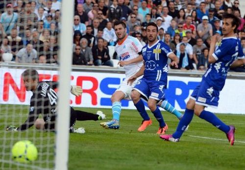 Marseille's Andre Pierre Gignac (C) scores a goal in front of Bastia's Mickael Landreau (L) in Marseille, May 4, 2013