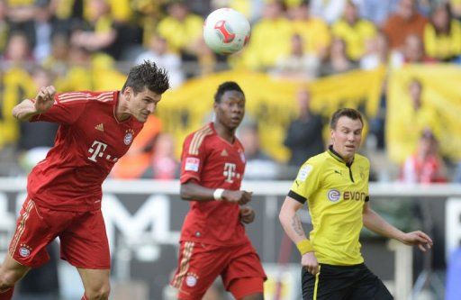 Bayern Munich&#039;s striker Mario Gomez (L) heads the ball for a goal in Dortmund, western Germany on May 4, 2013