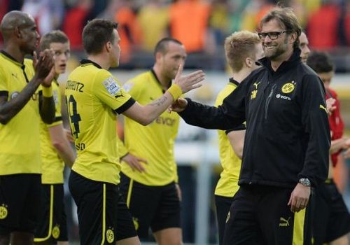 Dortmund's head coach Juergen Klopp (R) congratulates his players in Dortmund, Germany on May 4, 2013