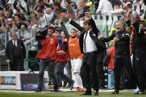 Juventus&#039; coach Antonio Conte celebrates after his team wins the Scudetto, the Italian Serie A title, on May 5, 2013