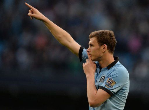 Manchester City&#039;s Edin Dzeko celebrates after scoring in Manchester on May 7, 2013