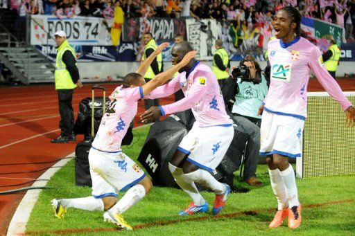 Evian&#039;s Nadjib Baouia (C) is congratulated by his teammates after scoring on May 8, 2013 a