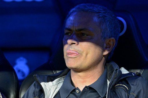 Real Madrid&#039;s Jose Mourinho sticks out his tongue at the Santiago Bernabeu stadium in Madrid on May 8, 2013