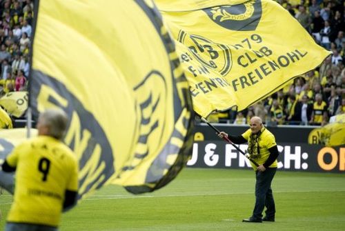 Borussia Dortmund flags are waved on the pitch prior to a Bundesliga match against Bayern Munich on May 4, 2013