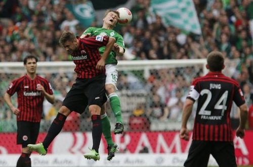 Bremen's Felix Kroos and Frankfurt's Vadim Demidov jump for the ball on May 11, 2013 in Bremen