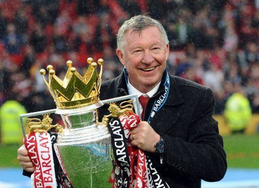 Manchester United manager Alex Ferguson holds the Premier League trophy after his side defeated Swansea on May 12, 2013