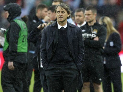 Manchester City manager Roberto Mancini reacts after his team&#039;s defeat in the FA Cup final against Wigan on May 11, 2013