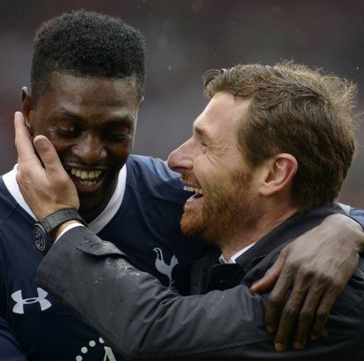 Tottenham Hotspur manager Andre Villas-Boas (R) hugs striker Emmanuel Adebayor at the end of their match on May 12, 2013