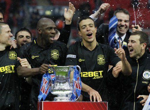 Wigan Athletic players celerbate with the FA Cup after defeating Manchester City on May 11, 2013