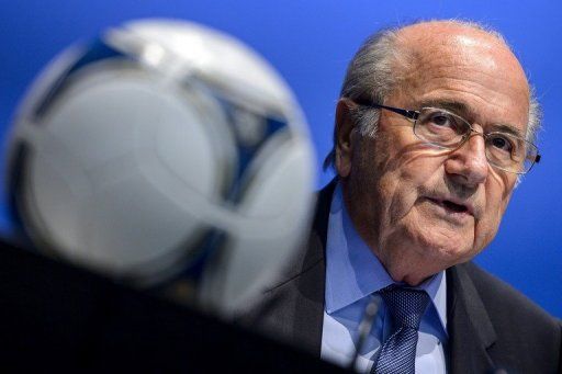 FIFA President Sepp Blatter looks on behind a football during a press conference on September 28, 2012 in Zurich