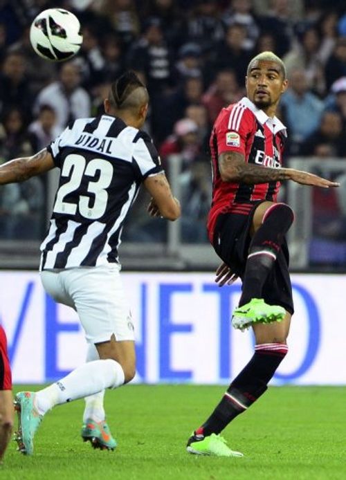 Kevin-Prince Boateng (right) takes on Juventus' Arturo Vidal in Turin on April 21, 2013