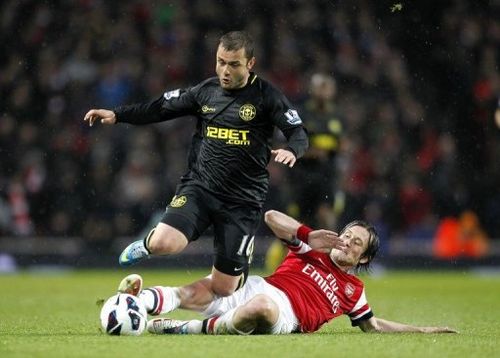 Arsenal midfielder Tomas Rosicky (R) challenges Wigan's Shaun Maloney during their Premier League match on May 14, 2013