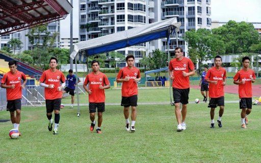 Aleksandar Duric (3rd R) trains with teammates at the Clementi Stadium in Singapore on May 10, 2013