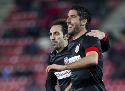 Atletico Madrid's Juanfran and Raul Garcia (R) are pictured during their match against Mallorca on January 6, 2013